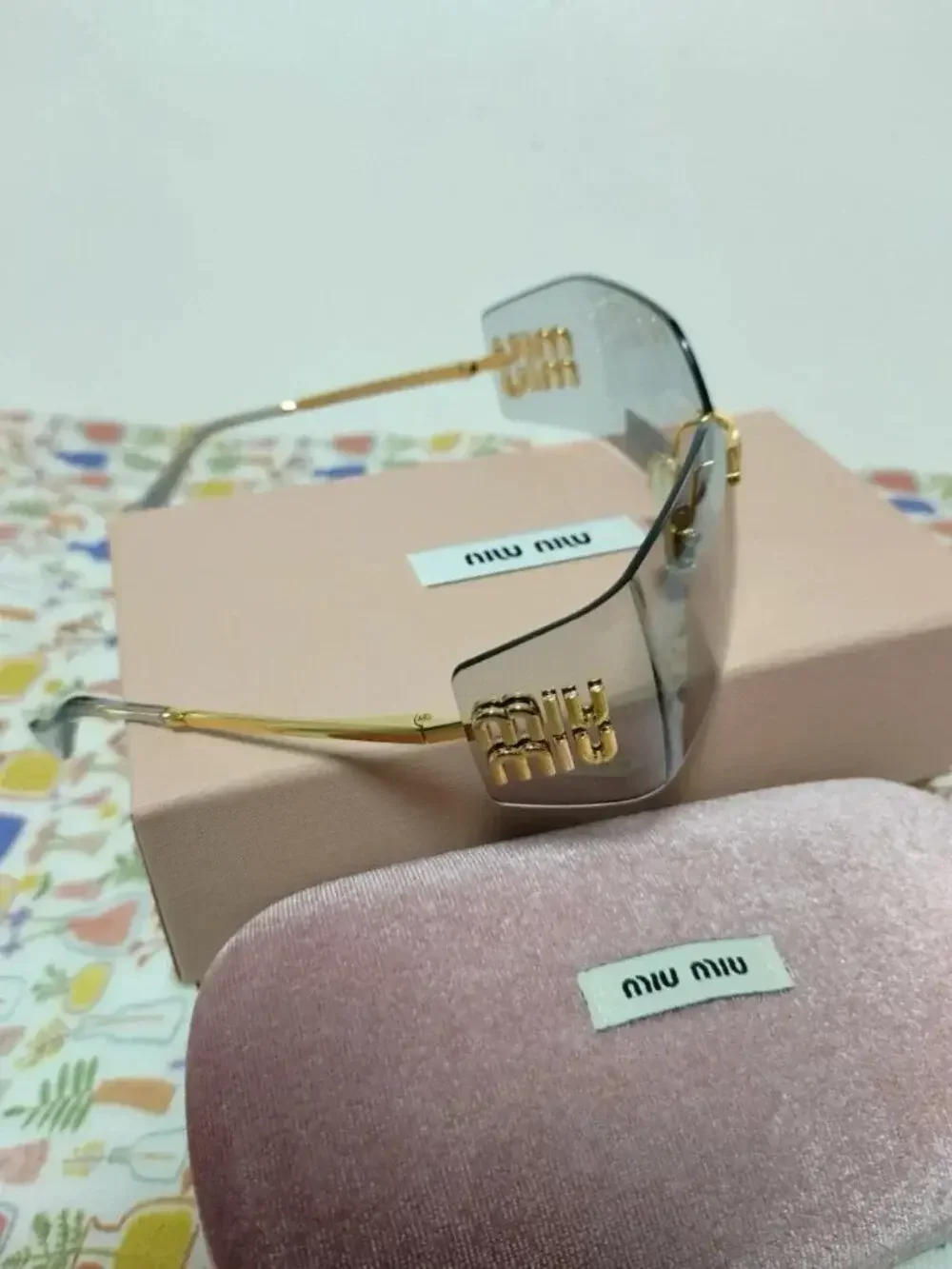 Miu Miu Rimless Grey Sunglasses with Oversized Gold Logo